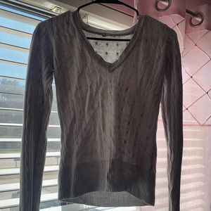 A knit tight fitting grey sweater